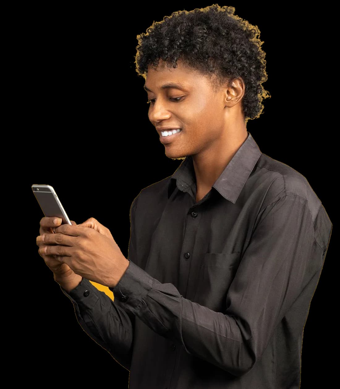 A young man smiling at his phone