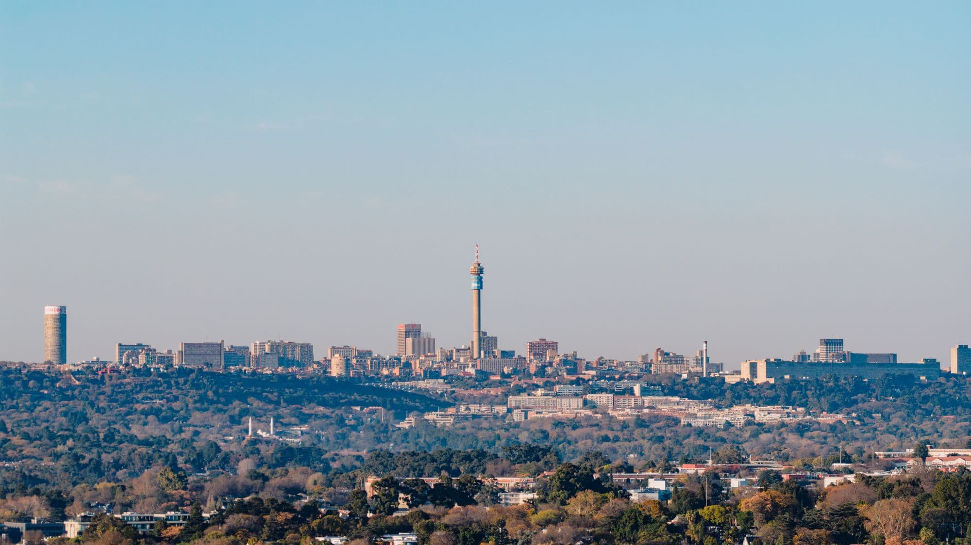 Johannesburg skyline and the Hillbrow tower above leafy suburbs